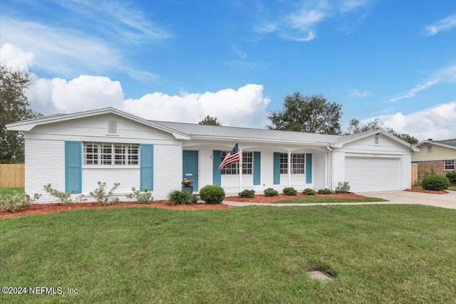 ranch-style house featuring an attached garage, a front lawn, and brick siding