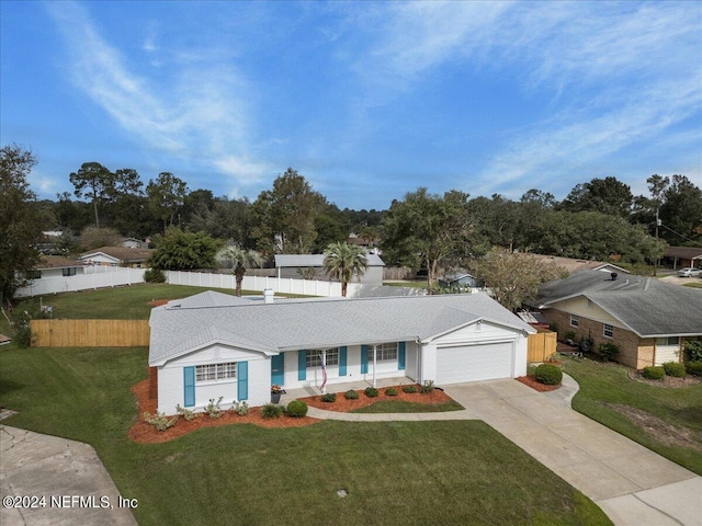 ranch-style house featuring a garage, driveway, fence, and a front lawn