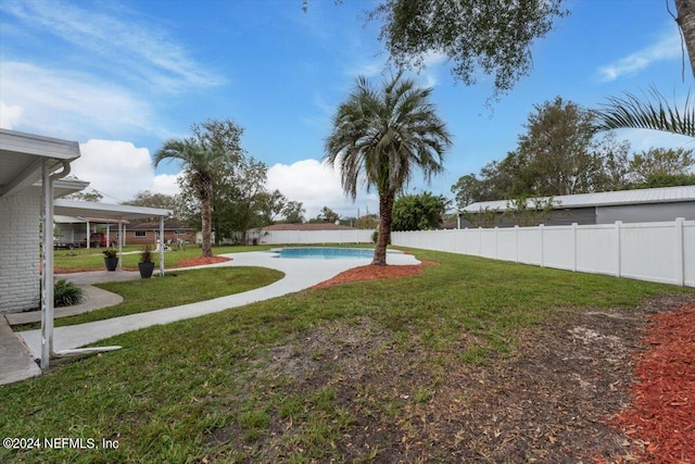 view of yard with a fenced in pool