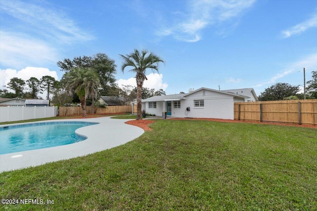 view of swimming pool featuring a yard, a fenced backyard, and a fenced in pool