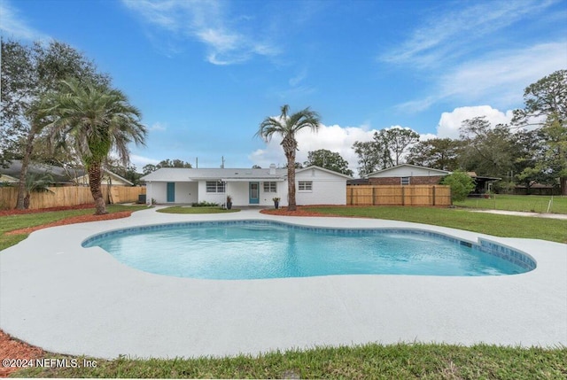 view of swimming pool featuring a yard and a patio area