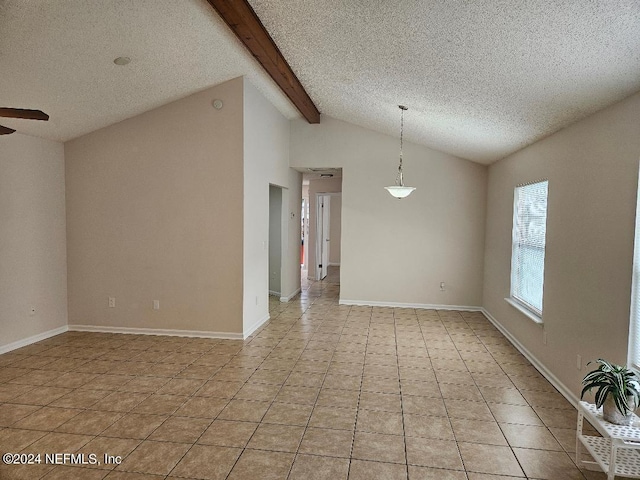 spare room with a textured ceiling, light tile patterned floors, ceiling fan, and vaulted ceiling with beams