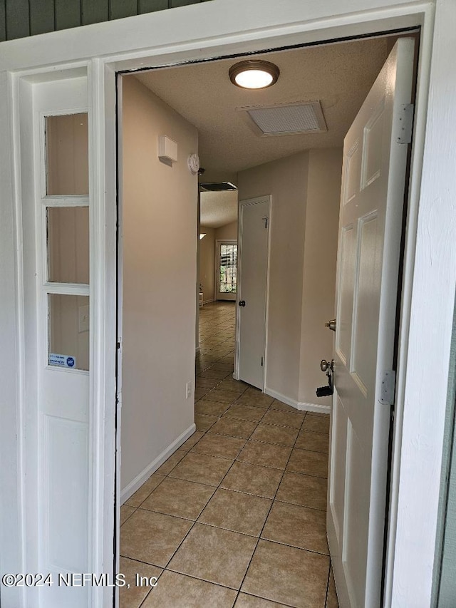 corridor with light tile patterned floors