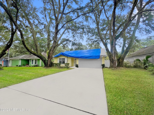 single story home featuring a front yard and a garage