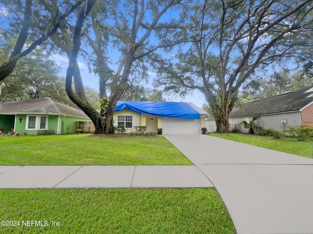 ranch-style home featuring a garage and a front yard