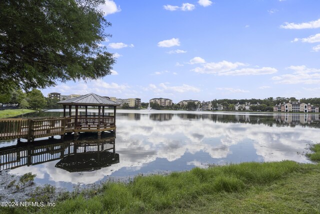 view of dock with a gazebo and a water view