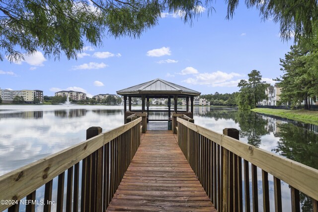 view of dock featuring a gazebo and a water view