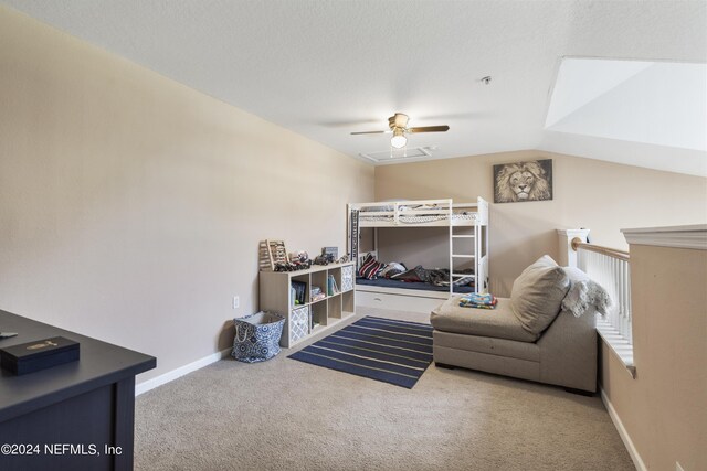 carpeted living room featuring lofted ceiling, ceiling fan, and a textured ceiling