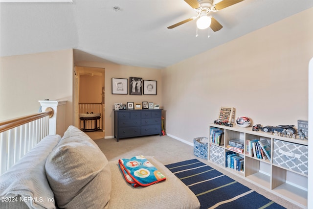 sitting room with lofted ceiling, carpet flooring, and ceiling fan