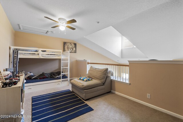 carpeted bedroom with lofted ceiling, ceiling fan, and a textured ceiling