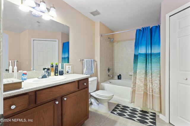 full bathroom with vanity, toilet, shower / bath combo with shower curtain, and tile patterned flooring