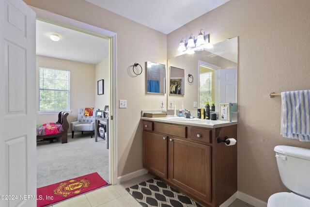 bathroom featuring vanity, toilet, and tile patterned flooring