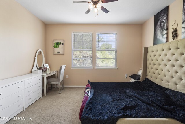 bedroom with ceiling fan and light carpet