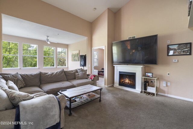 carpeted living room with lofted ceiling and ceiling fan