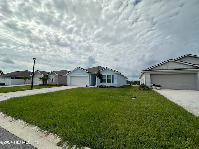 view of front facade with a front yard and a garage