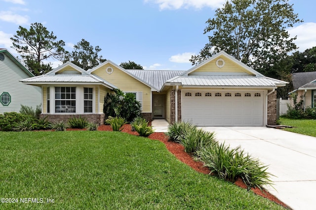 ranch-style house featuring a garage and a front lawn