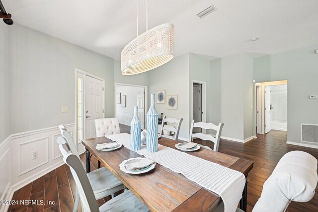 dining room with dark hardwood / wood-style flooring