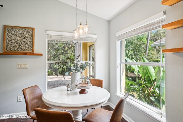 dining area with vaulted ceiling and hardwood / wood-style flooring