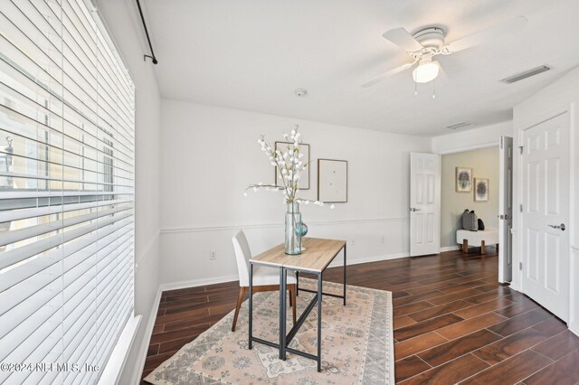 office area with ceiling fan and dark wood-type flooring