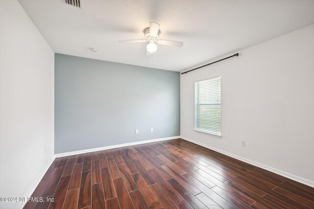 unfurnished room featuring ceiling fan, a textured ceiling, and dark wood-type flooring