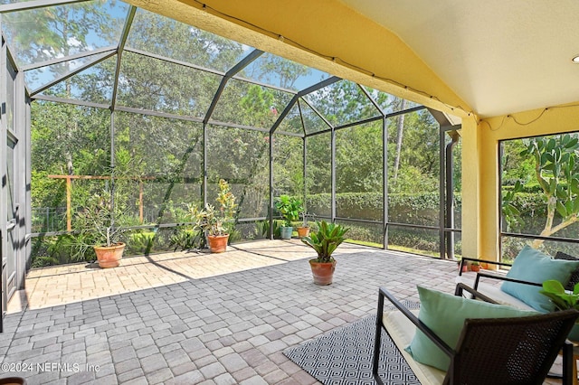 view of patio featuring a lanai