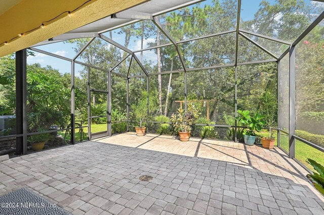 view of patio / terrace featuring a lanai