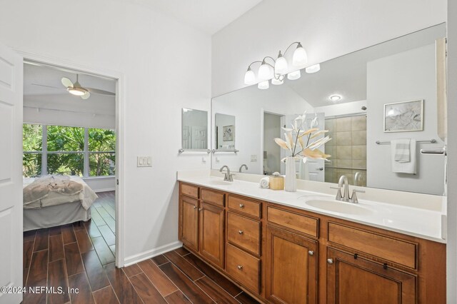 bathroom with walk in shower, vanity, vaulted ceiling, and hardwood / wood-style flooring