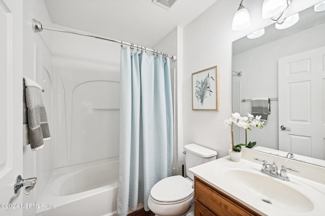 full bathroom featuring vanity, toilet, a textured ceiling, and shower / bath combo