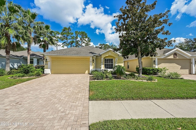 ranch-style home with a front lawn and a garage