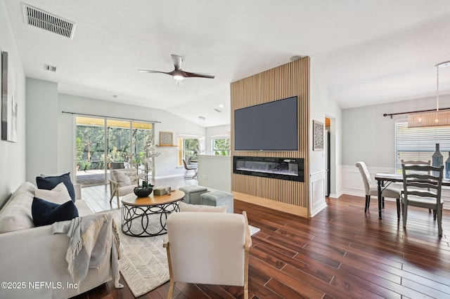 living room featuring lofted ceiling, a wealth of natural light, dark hardwood / wood-style flooring, and ceiling fan