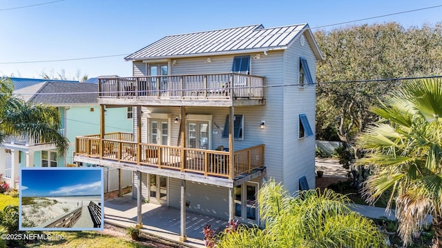 rear view of property featuring a balcony and a patio area