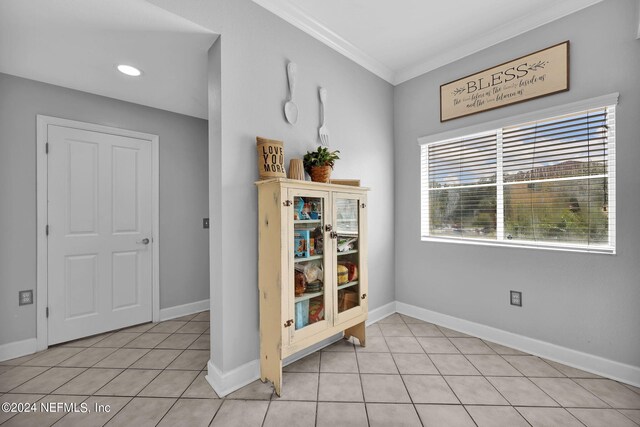 tiled dining area featuring ornamental molding