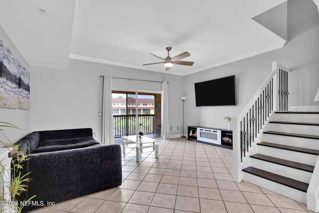 tiled living room featuring crown molding and ceiling fan