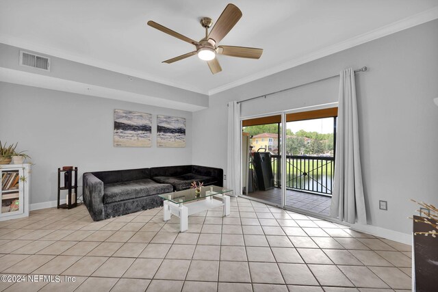 living room featuring ceiling fan, ornamental molding, and light tile patterned flooring