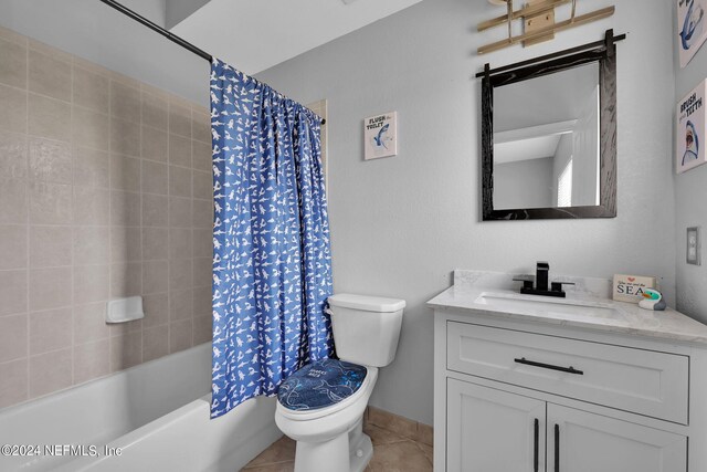 full bathroom featuring vanity, toilet, tile patterned floors, and shower / bath combo with shower curtain