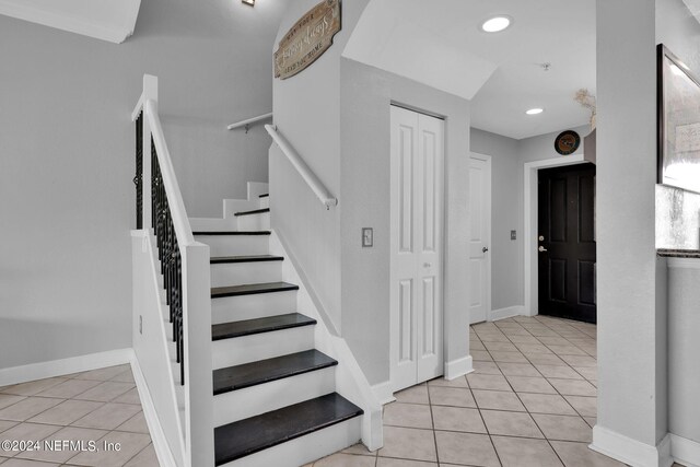 staircase featuring tile patterned flooring