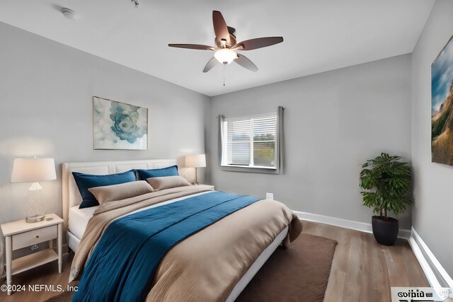 bedroom with wood-type flooring and ceiling fan