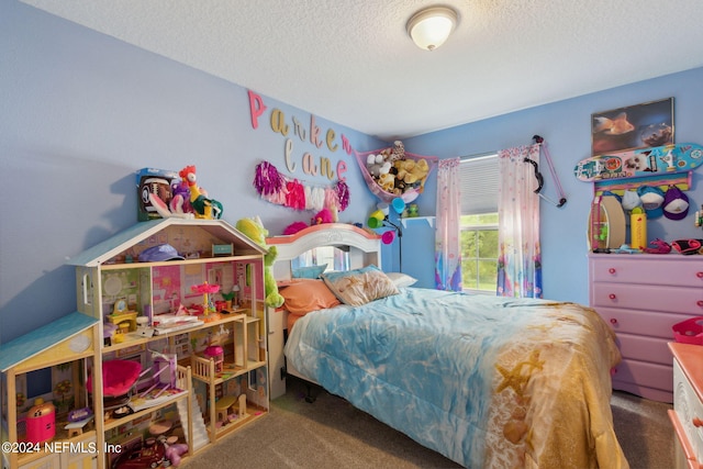 carpeted bedroom featuring a textured ceiling