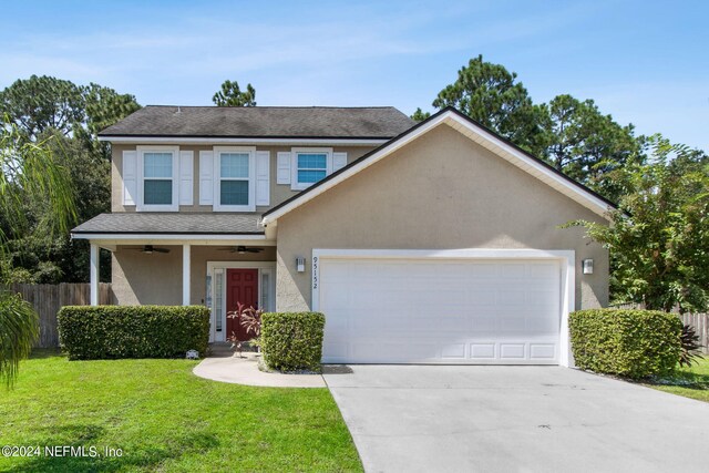 view of front of home featuring a garage and a front yard