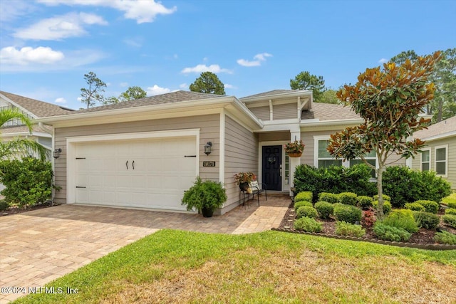 view of front of home featuring a front yard and a garage