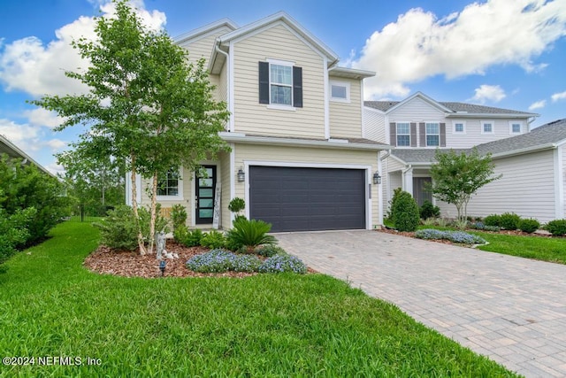 view of front of property featuring a front yard and a garage