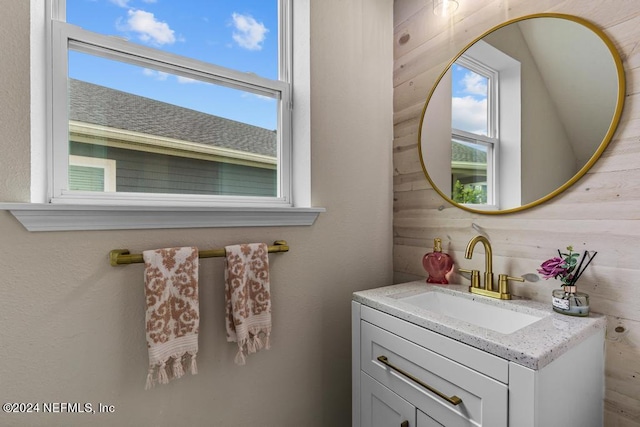 bathroom with vanity and wooden walls