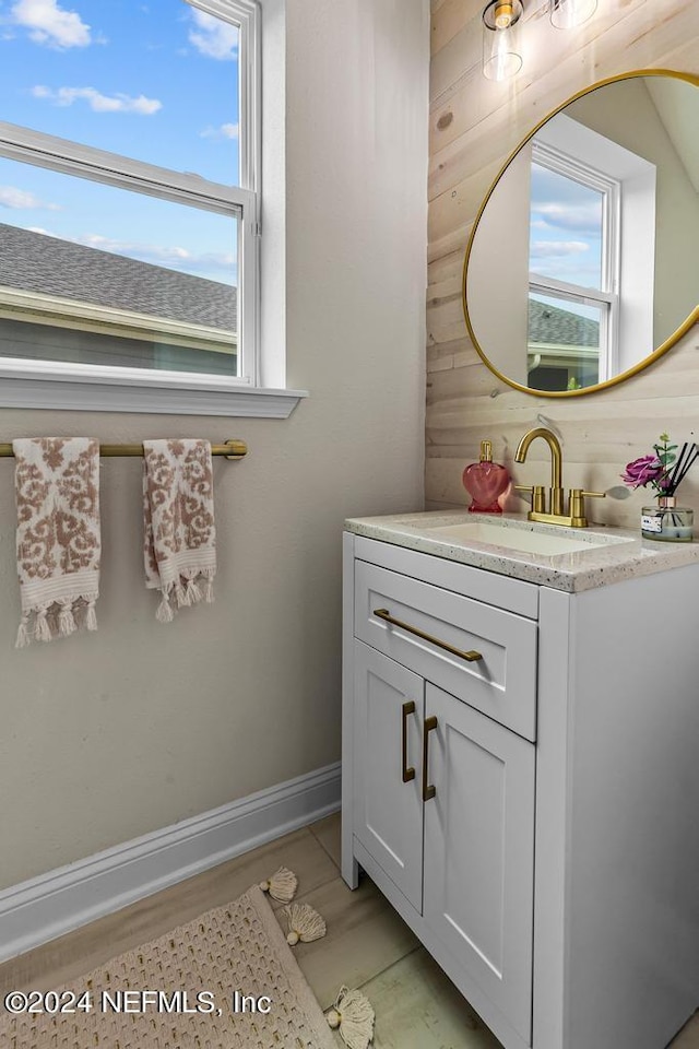 bathroom with vanity and wooden walls