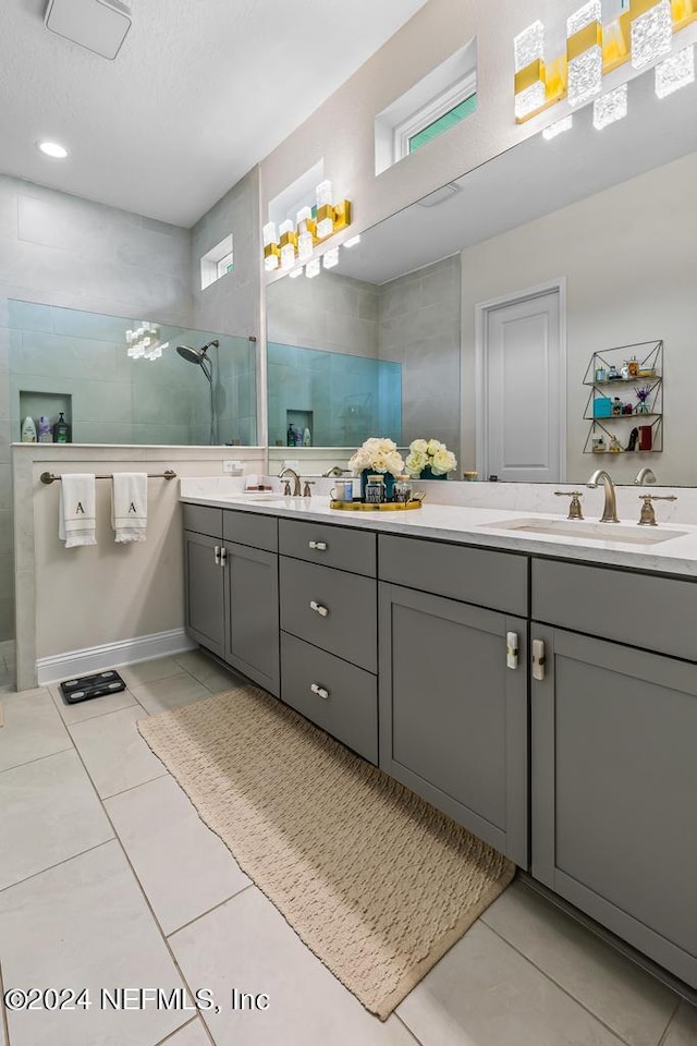 bathroom featuring tile patterned flooring, vanity, a shower, and a textured ceiling