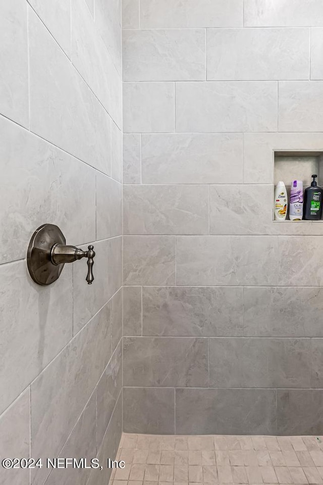 bathroom with a tile shower