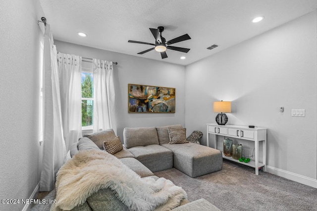 carpeted living room featuring ceiling fan