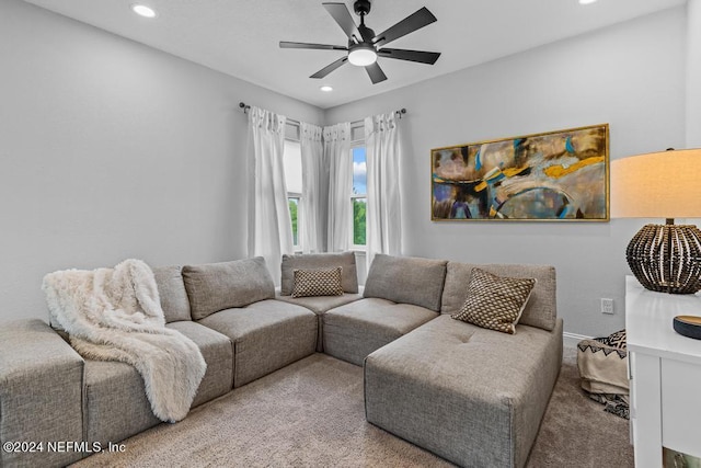 carpeted living room featuring ceiling fan