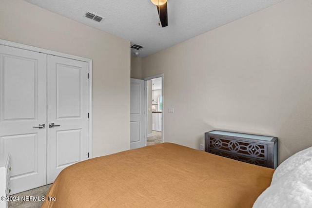 bedroom with carpet, ceiling fan, and a closet