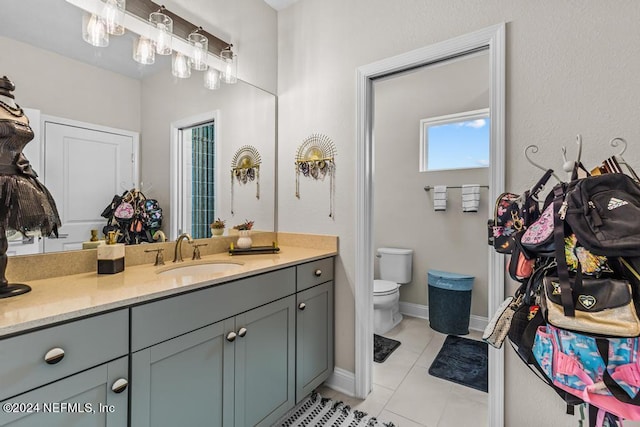 bathroom with vanity, toilet, and tile patterned floors