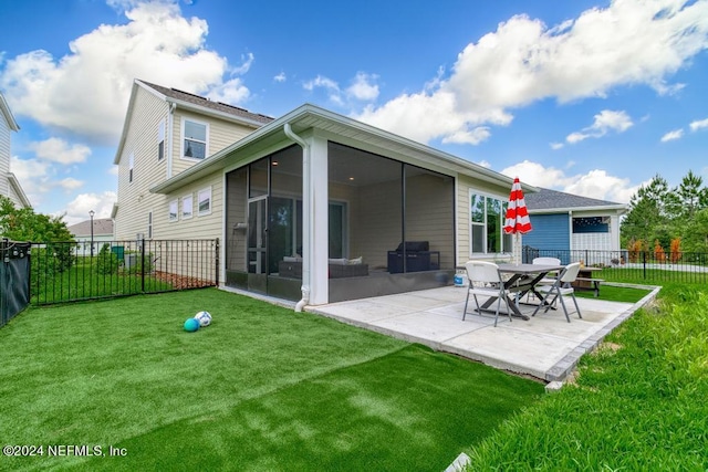 back of property featuring a lawn, a patio, and a sunroom